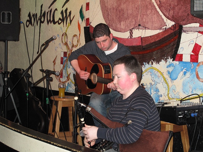 Darragh and Shane are playing music on stage.