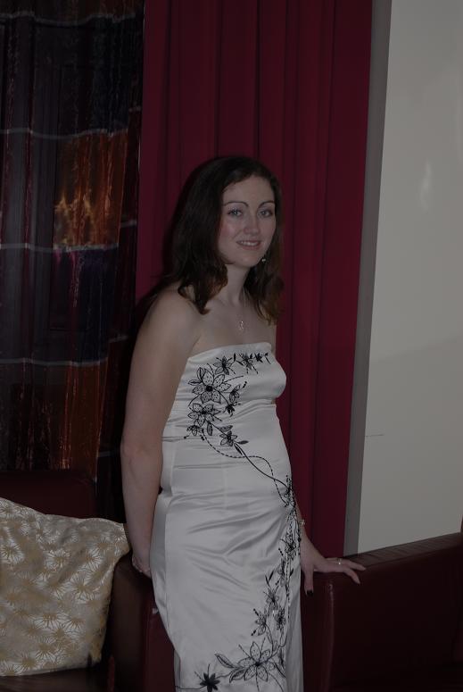 Emma standing with a dress on and her hair straightened.