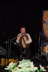 Darragh playing the Bodhran on stage.