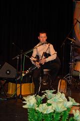 Darragh on stage playing the Uilleann pipes.