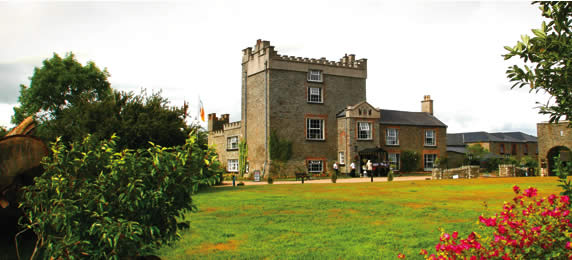 A picture taken from the Darver castle website showing the side of the castle.  The lush grounds surrounding it are also seen.