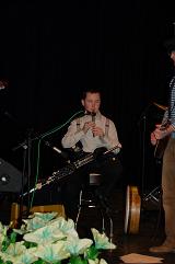 Darragh playing the high chiefton D whistle on stage.