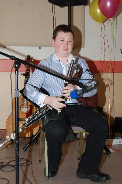 A picture of me playing the pipes on a small stage.