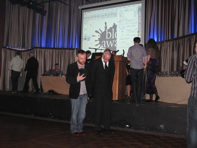 Rick and Damien are bowing with respect to the coffin