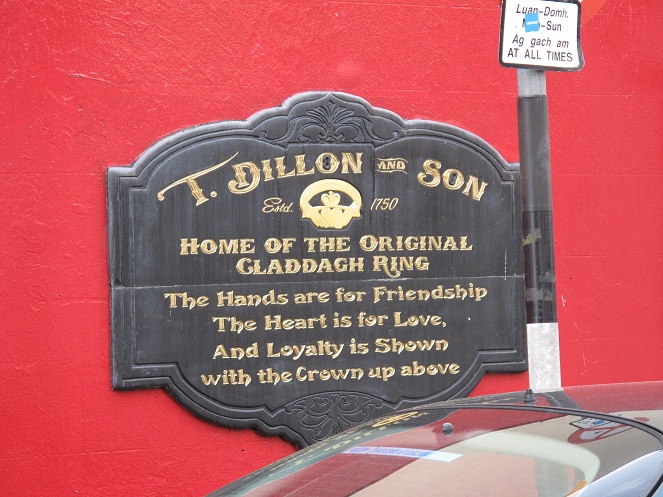 This is a plaque on the side of a building. It gives some of the history of Claddagh as it origionated in Galway.